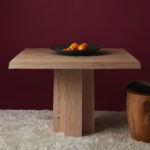 The Soma pedestal with a wood top, decorated with oranges.