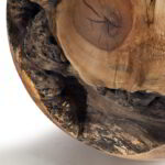 Cropped photo of a Solid maple sphere against a white background.