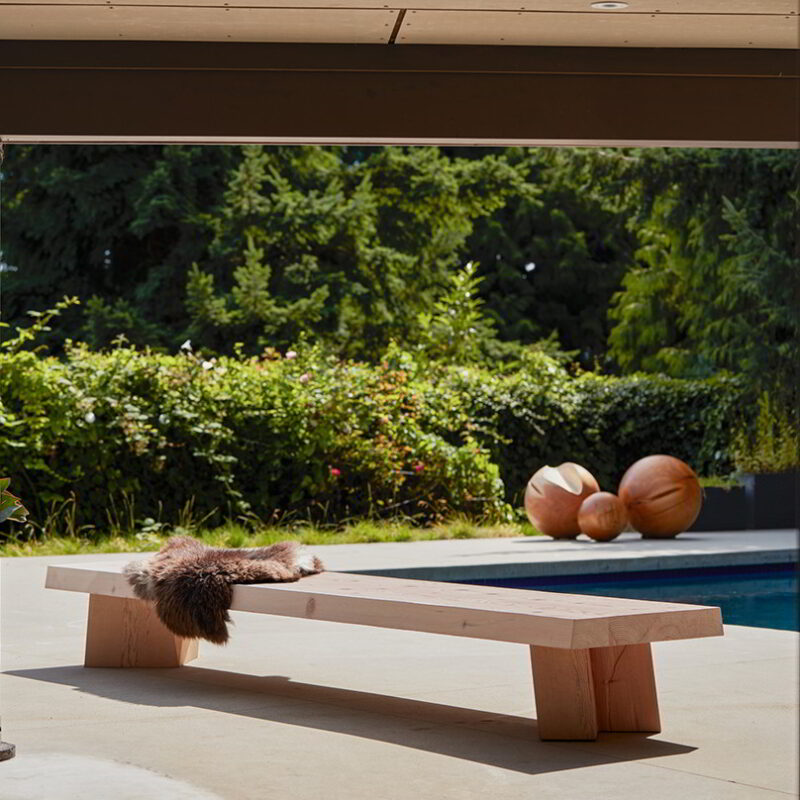The sweep bench in an outdoor setting with three solid spheres in the background.
