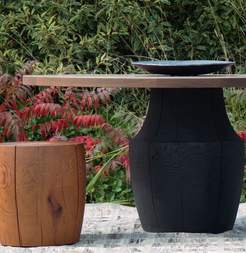 The Chelsea table with a scorched base and thermalwood top and the DR-2 in an outdoor setting.