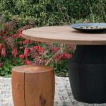 The Chelsea table with a scorched base and thermalwood top and the DR-2 in an outdoor setting.