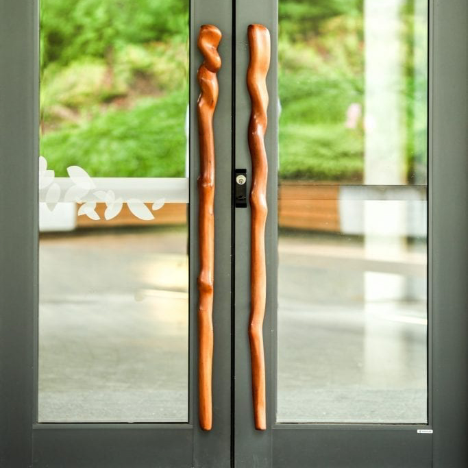 Wooden walking sticks used as door handles.