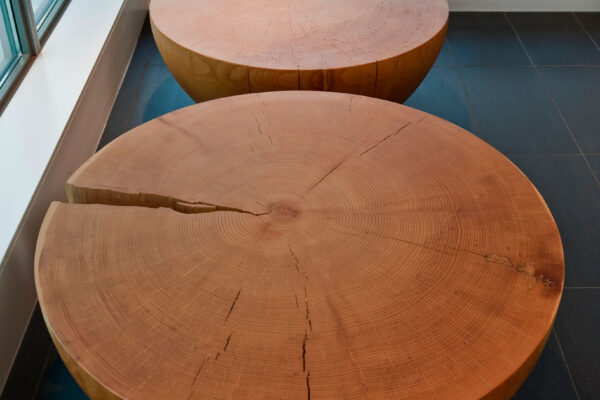 Two white pine drum tables pictured in a residential space.