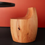 The side profile of the Chelsea stool is pictured against a red background.